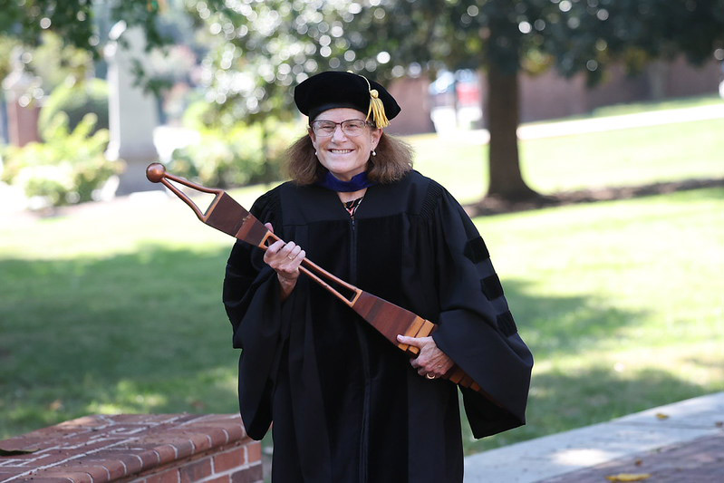 Grand Marshal Strickland smiles while carrying the Converse mace.