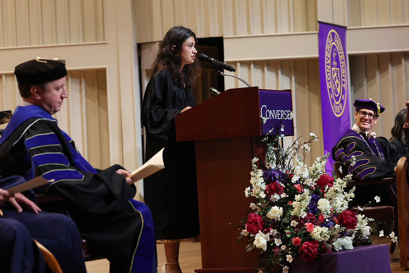 Ninel speaks at the podium at Convocation 2026.