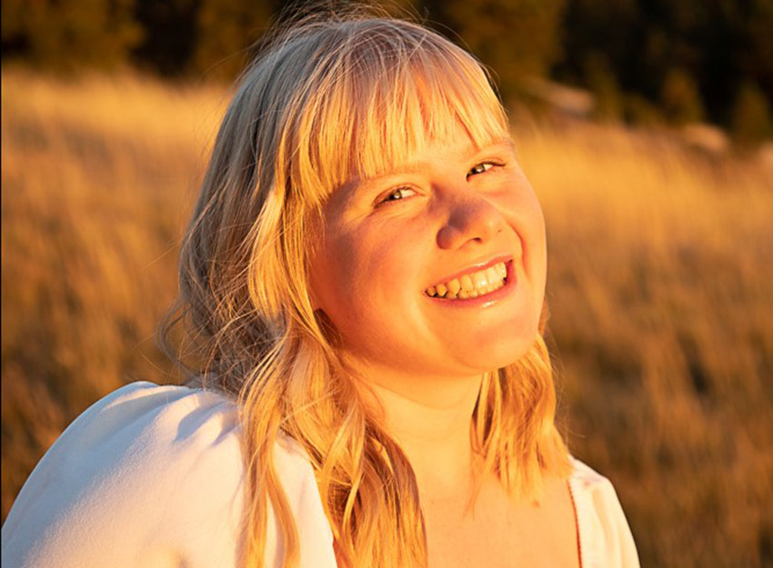 Outdoor photo of Addie in the sunlight.