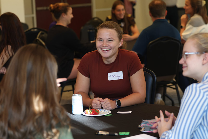 Converse students laugh and talk during a break at the event.