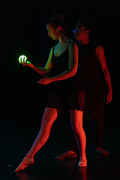 A dramatic moment during a performance of Ron holding a small ball of light.