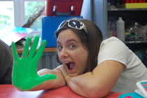 Carly displays a green painted hand